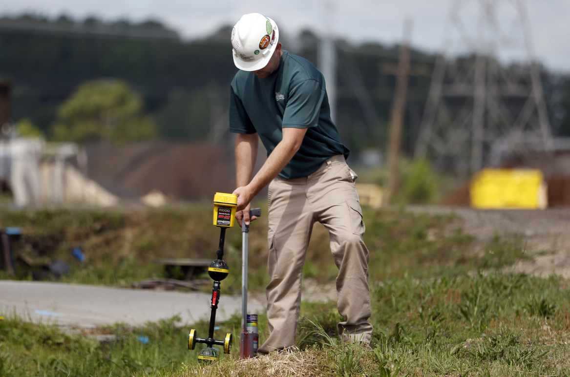 A utility locator with The Underground Detective, based in Cleveland, Ohio, attempts to find underground utilities while on a job site.
